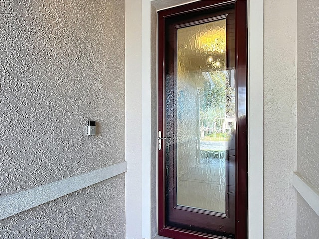 property entrance featuring stucco siding