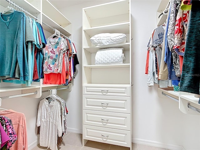 walk in closet with tile patterned flooring