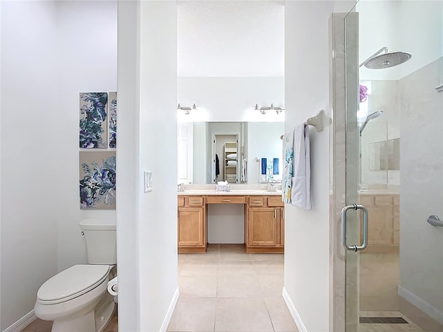 full bathroom with vanity, baseboards, a stall shower, tile patterned floors, and toilet