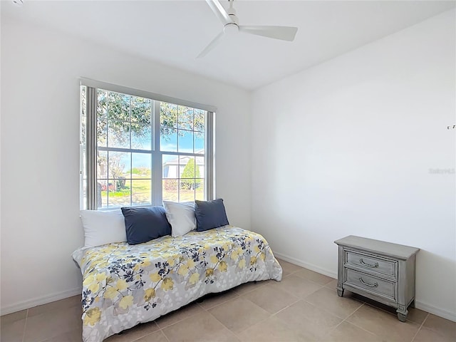 bedroom with light tile patterned flooring, baseboards, and ceiling fan