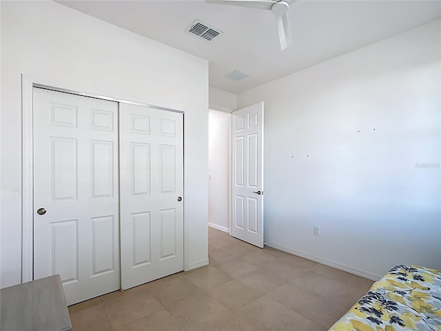 unfurnished bedroom with baseboards, visible vents, a closet, and ceiling fan