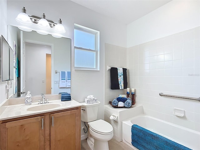 bathroom featuring vanity, toilet, and a tub