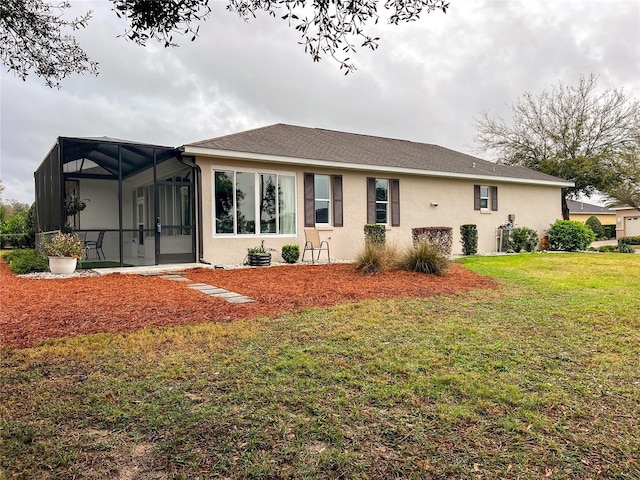 rear view of property featuring glass enclosure, a lawn, and stucco siding