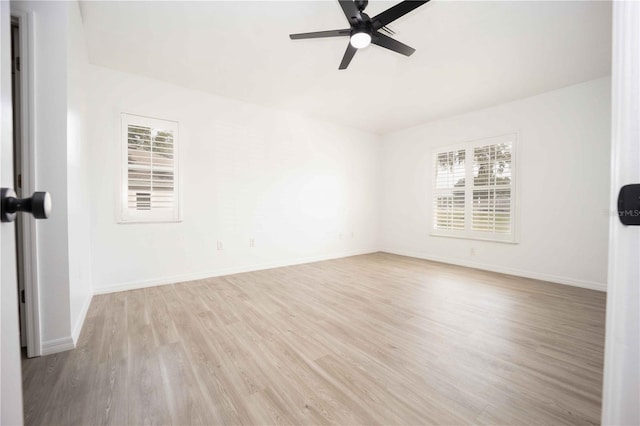 unfurnished room with baseboards, light wood-style floors, and a ceiling fan