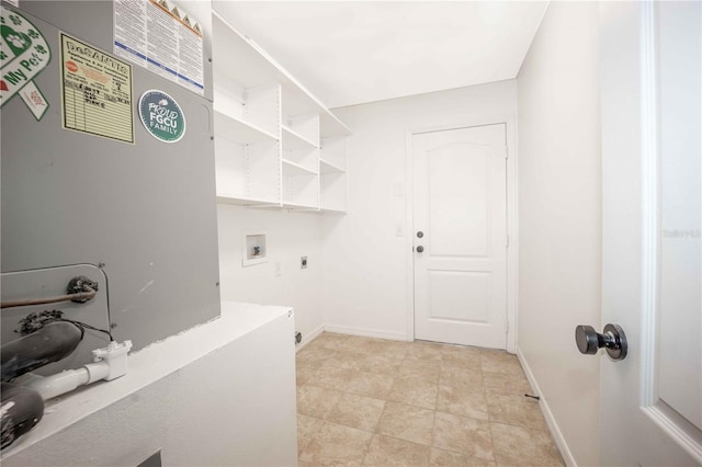 washroom with laundry area, hookup for a washing machine, hookup for an electric dryer, and baseboards