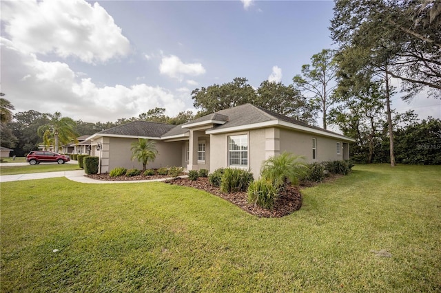 single story home with stucco siding and a front lawn