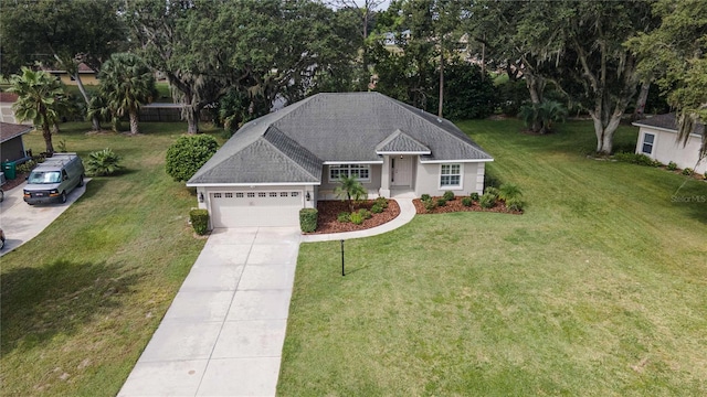 single story home with a front lawn, an attached garage, and driveway