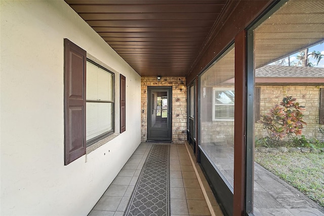 doorway to property featuring stone siding and stucco siding