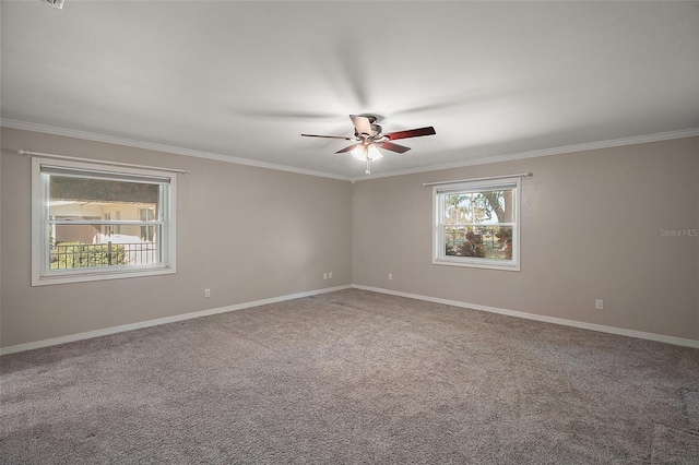 carpeted spare room with ceiling fan, baseboards, and ornamental molding