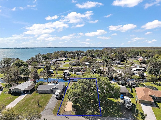 drone / aerial view with a water view and a residential view