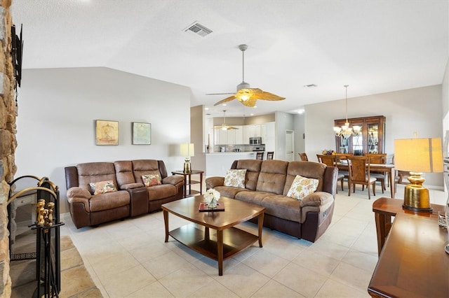 living room with light tile patterned floors, visible vents, ceiling fan with notable chandelier, and lofted ceiling