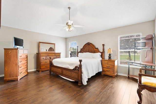 bedroom with baseboards, dark wood-type flooring, and ceiling fan