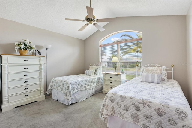 bedroom with a ceiling fan, lofted ceiling, light colored carpet, and a textured ceiling