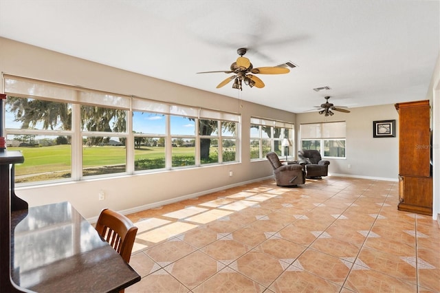 sunroom featuring visible vents and ceiling fan