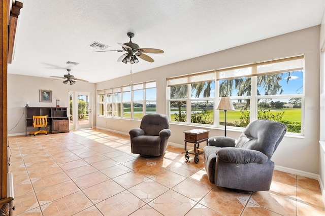 sunroom / solarium with visible vents and a ceiling fan