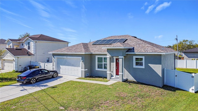 view of front facade with stucco siding, fence, concrete driveway, an attached garage, and solar panels