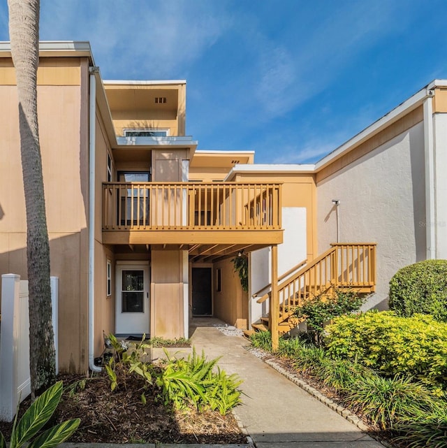 1051 S Highland St Unit 7E, Mount Dora, FL 32757 - back of property with stairs, stucco siding, and a balcony