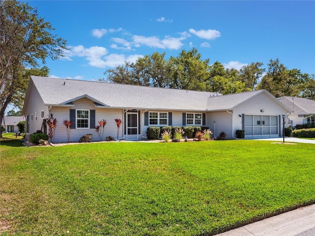 ranch-style home featuring a front lawn, concrete driveway, and a garage