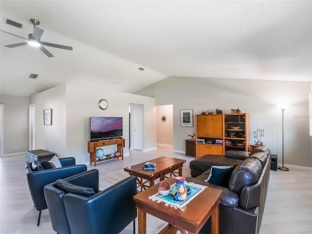 living area featuring visible vents, a textured ceiling, ceiling fan, and vaulted ceiling