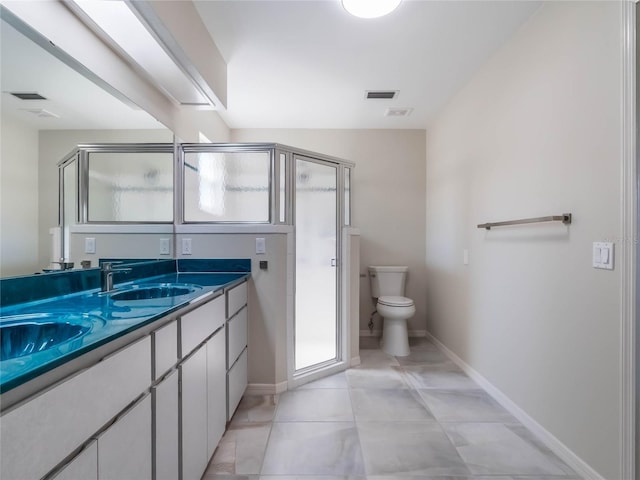 bathroom featuring vanity, toilet, baseboards, and visible vents