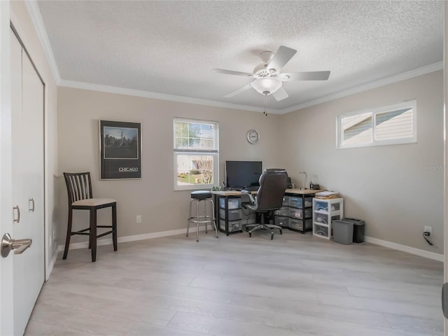 office space featuring a textured ceiling, light wood-style flooring, baseboards, and ornamental molding