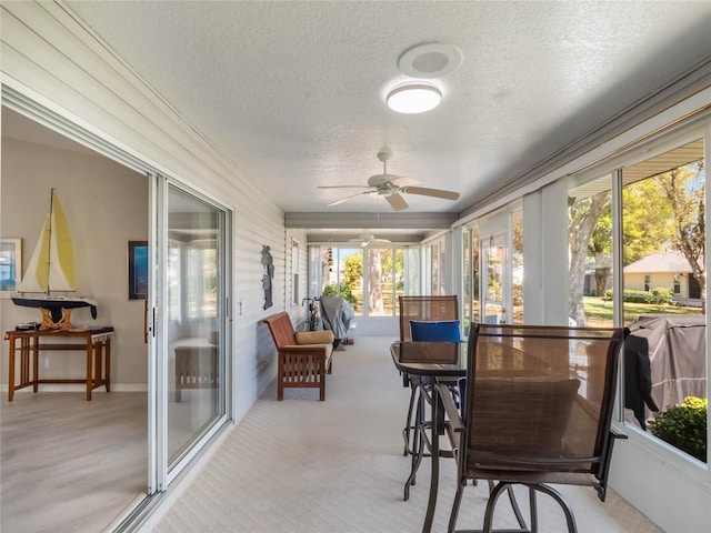 sunroom featuring ceiling fan