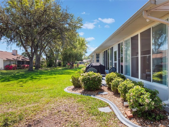 view of yard featuring a sunroom