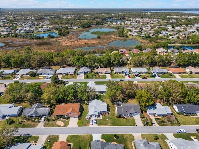 drone / aerial view with a residential view and a water view