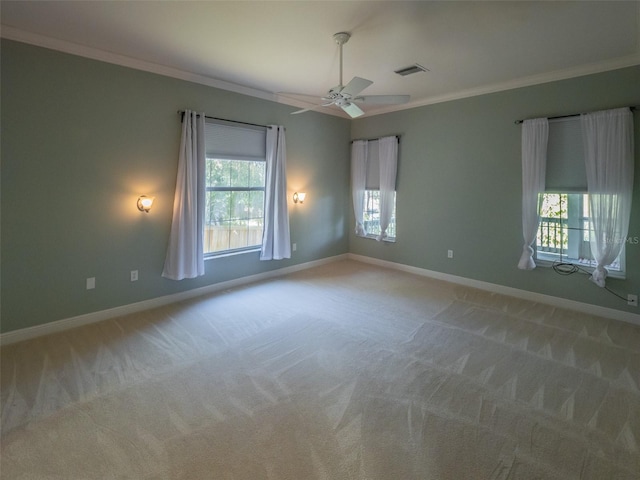 empty room with visible vents, baseboards, and crown molding