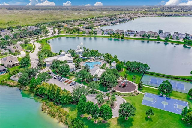 drone / aerial view with a residential view and a water view