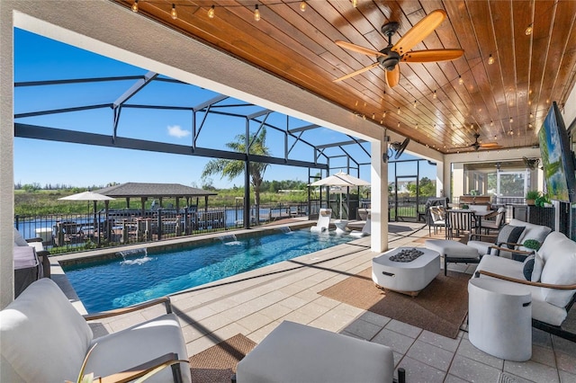 view of pool featuring a fenced in pool, a fire pit, fence, a lanai, and a patio area