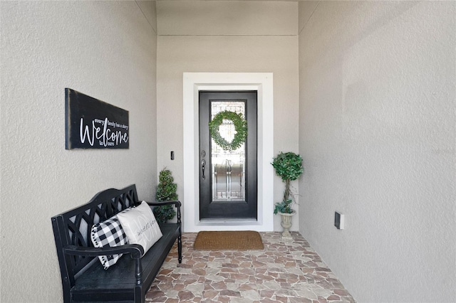 doorway to property with stucco siding