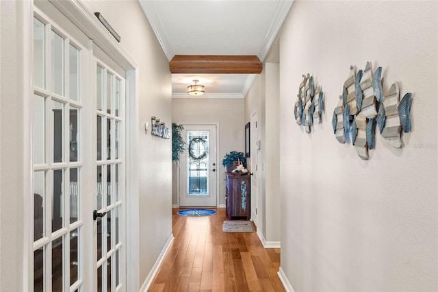 hallway with french doors, crown molding, baseboards, and wood-type flooring