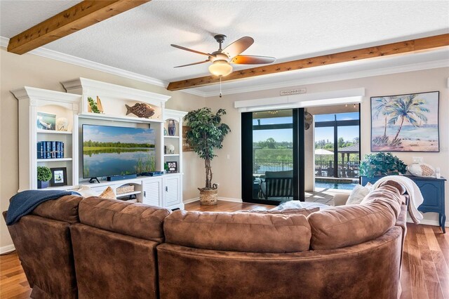 living room featuring beamed ceiling, wood finished floors, and a textured ceiling