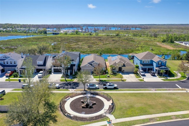 birds eye view of property with a residential view and a water view