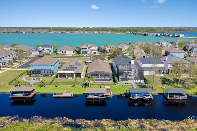 drone / aerial view featuring a residential view and a water view