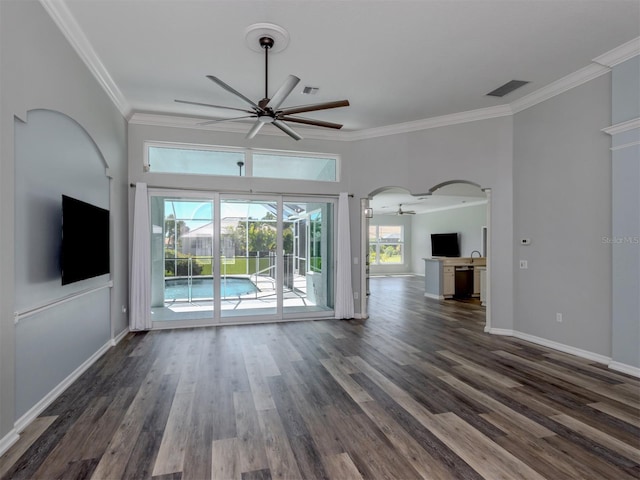 unfurnished living room with visible vents, baseboards, ceiling fan, dark wood finished floors, and ornamental molding