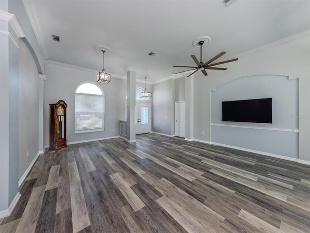 unfurnished living room featuring crown molding, wood finished floors, visible vents, and baseboards