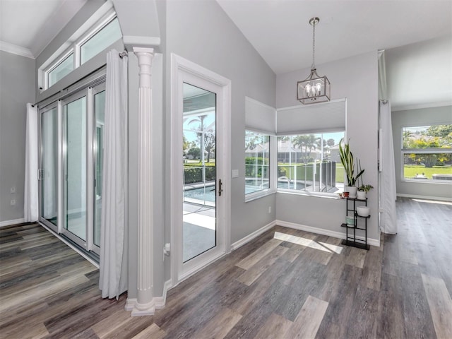 interior space featuring baseboards, a healthy amount of sunlight, and wood finished floors