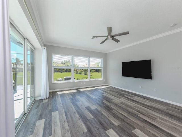 unfurnished living room with plenty of natural light, wood finished floors, baseboards, and ornamental molding