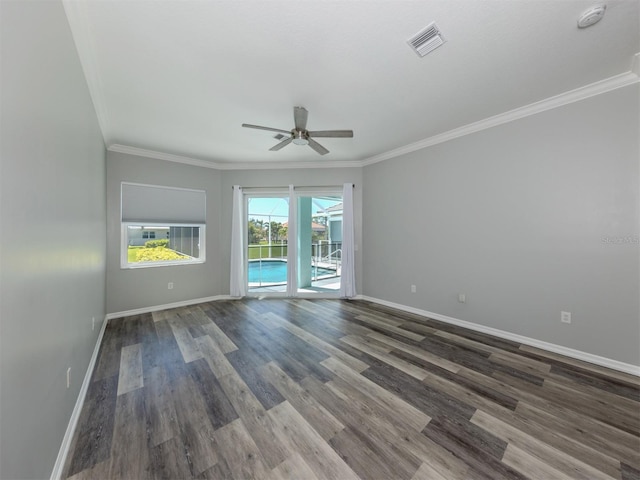 unfurnished room with visible vents, ceiling fan, baseboards, ornamental molding, and wood finished floors