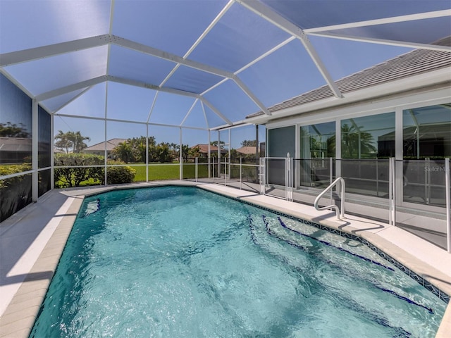 pool featuring glass enclosure and a patio