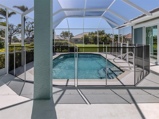 pool with a patio area and glass enclosure