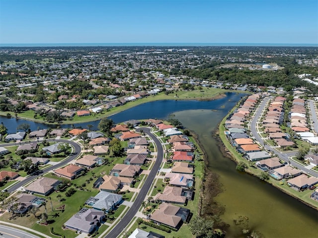 drone / aerial view with a residential view and a water view