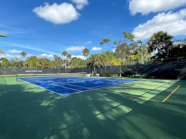 view of tennis court with fence