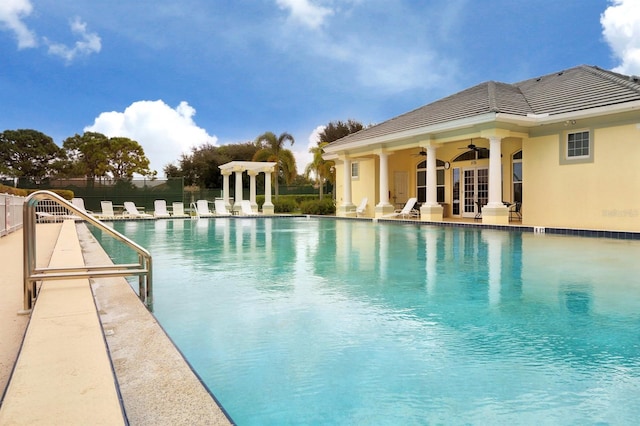 pool featuring a ceiling fan, a patio, fence, and french doors