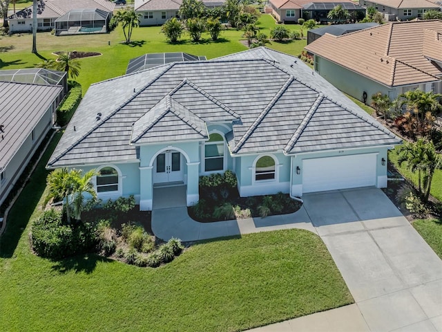 view of front of home featuring a residential view, stucco siding, driveway, and an attached garage