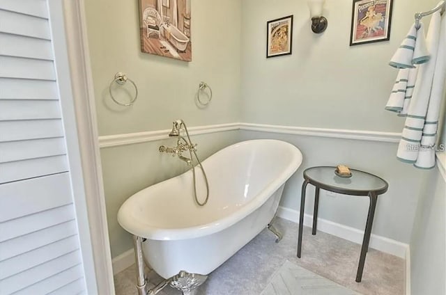 full bath with a soaking tub and baseboards