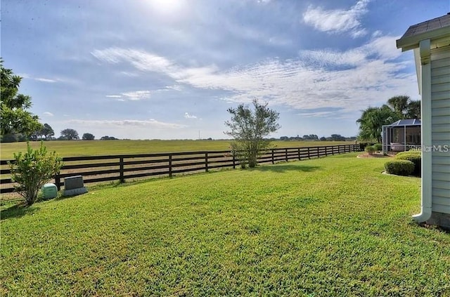 view of yard featuring a rural view and fence