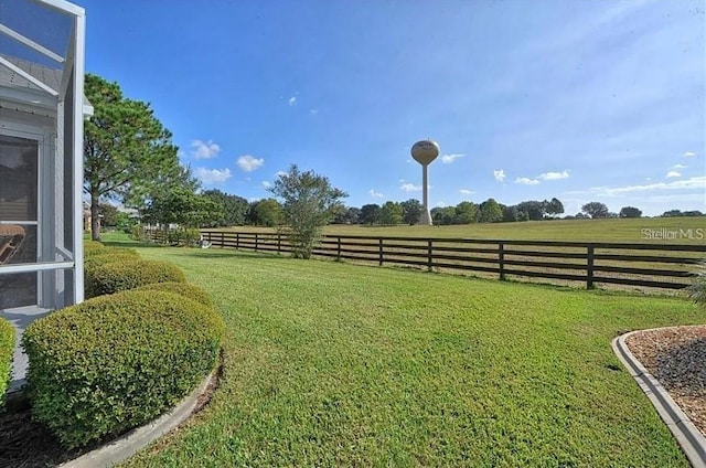 view of yard featuring a rural view and fence